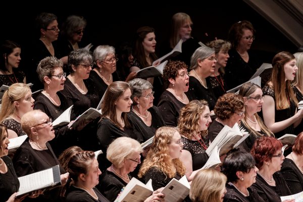 people in concert dress singing classical music